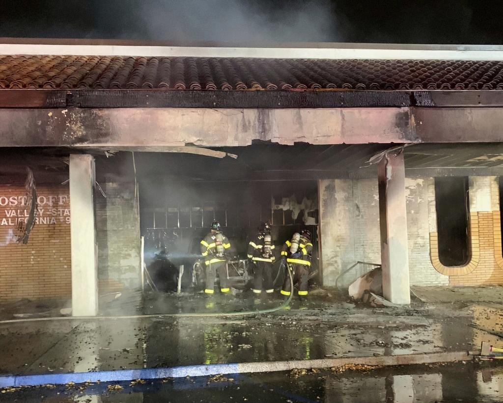 Fire burning after a car crashed into a Post Office.