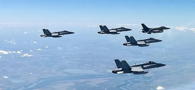 The F-18 fighter jets in formation.