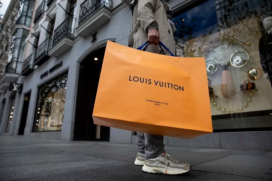 A person with a Louis Vuitton bag.