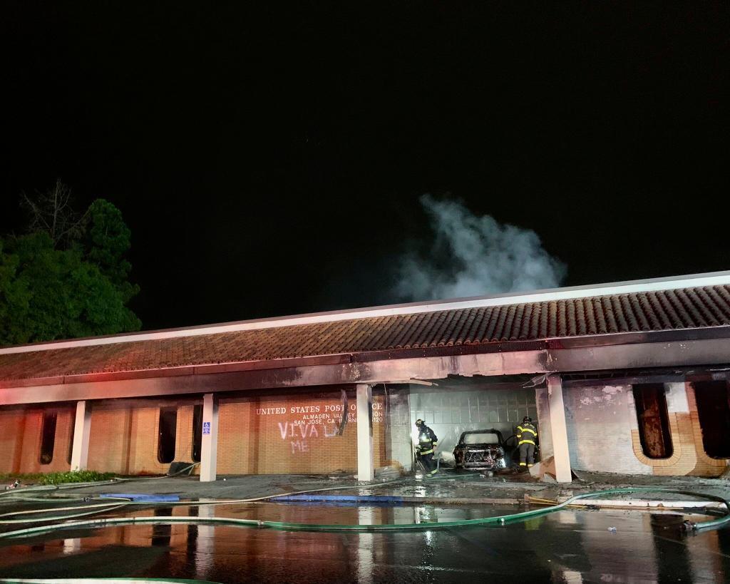 Fire burning after a car crashed into the Post Office