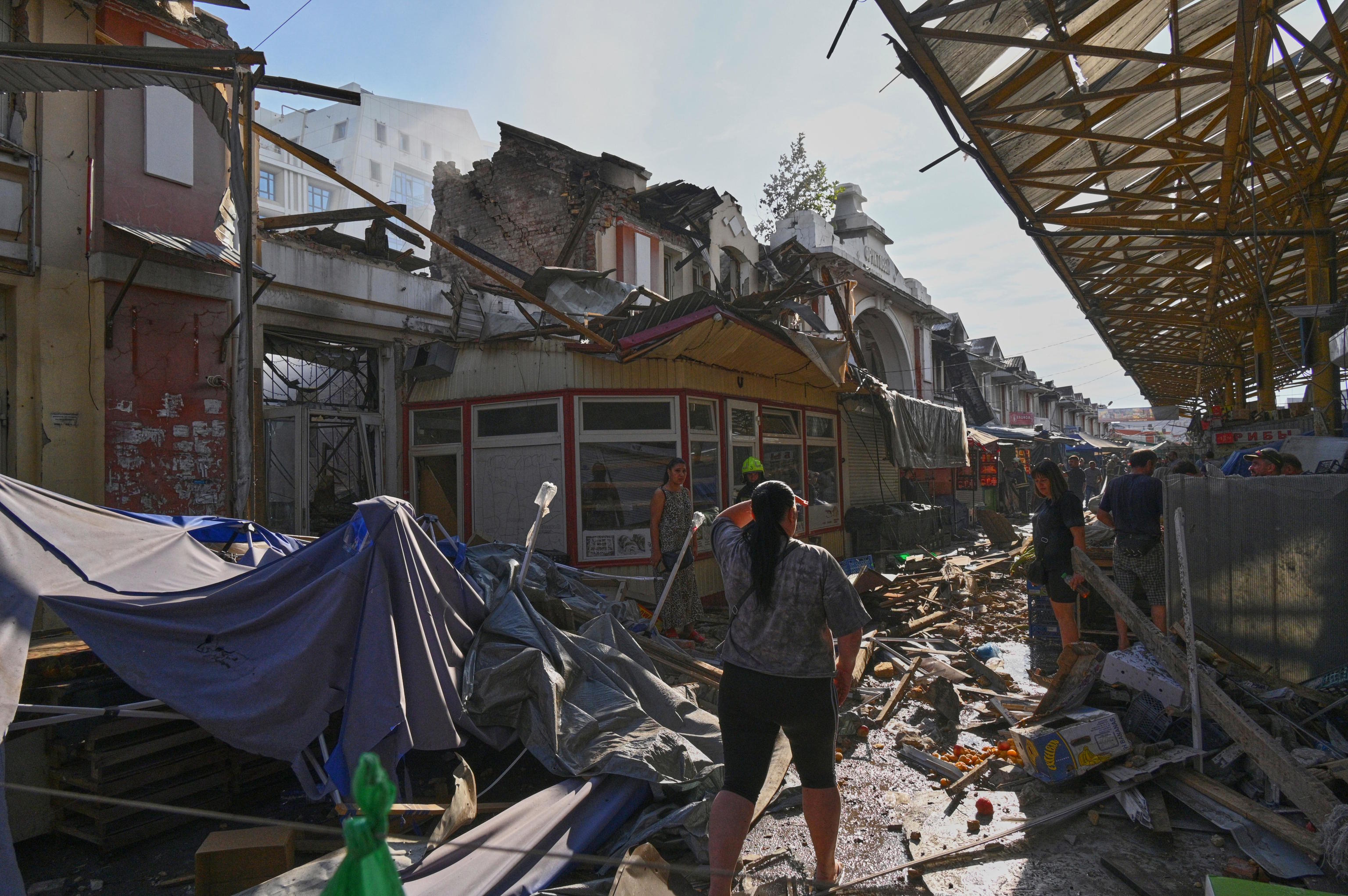 A woman looks at a city market following Russia's drone attack in Odesa.