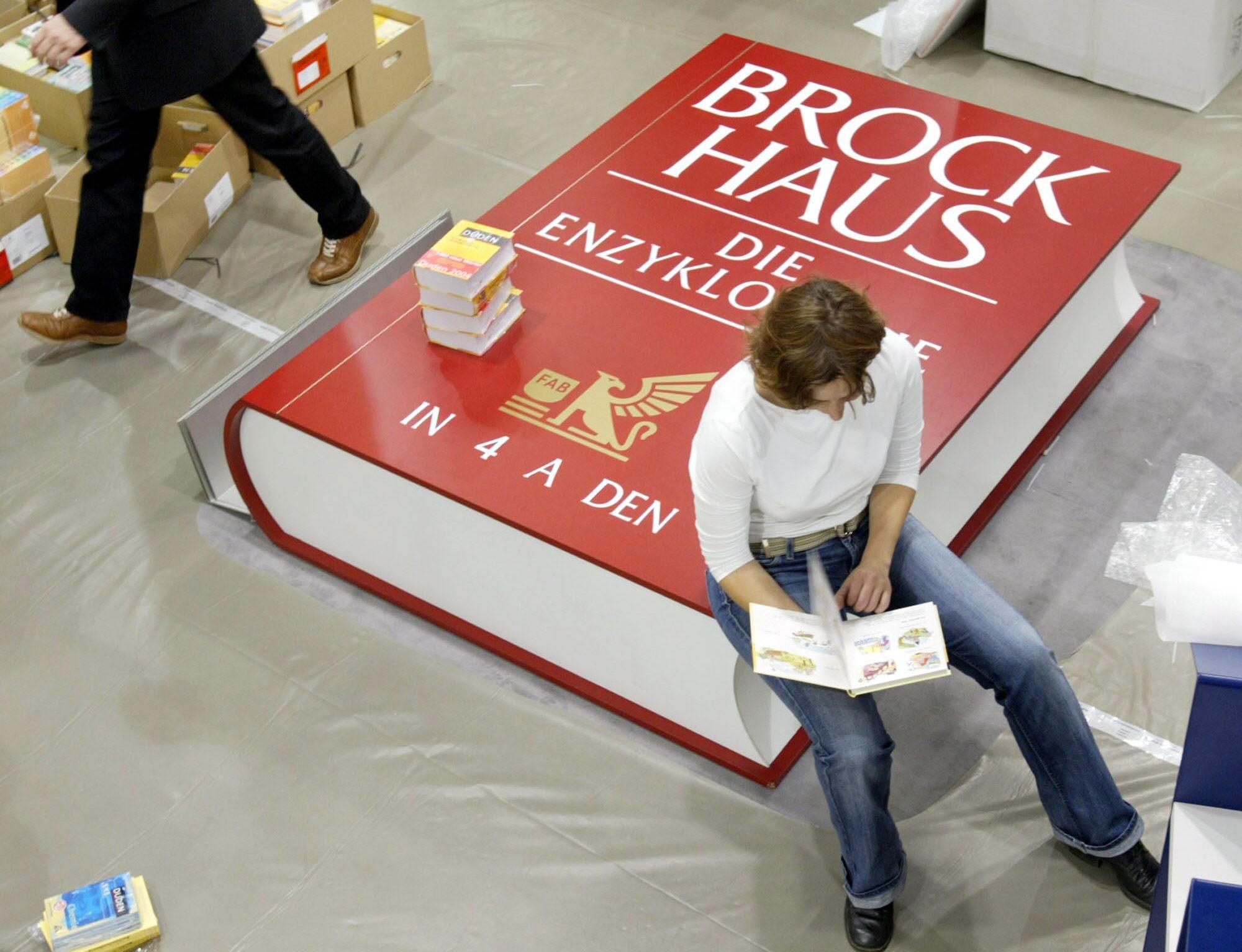 A women reads in a book at the International Book Fair in Frankfurt.