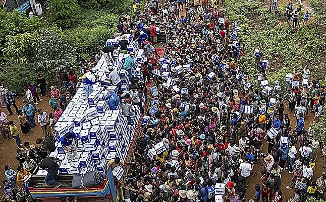 Hundreds of Cambodians displaced by war receive water.