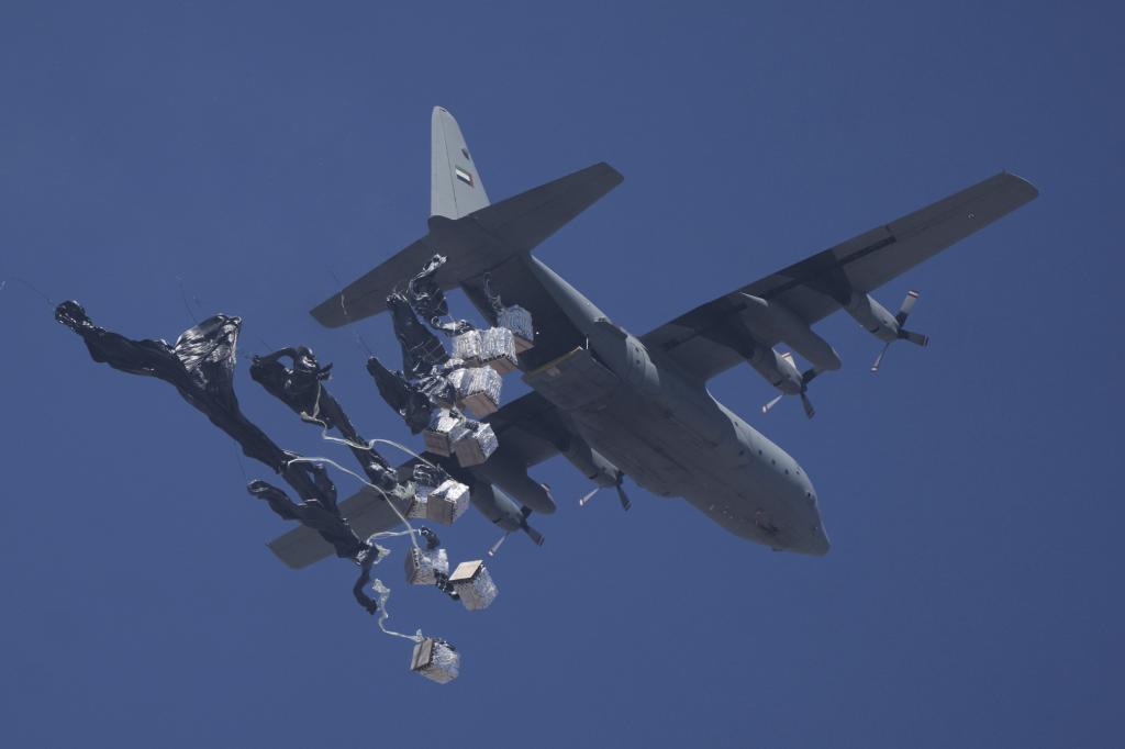 Humanitarian aid is airdropped to Palestinians over Gaza City.