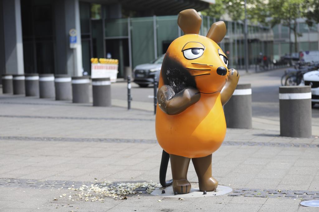 A mouse statue that has been set on fire.