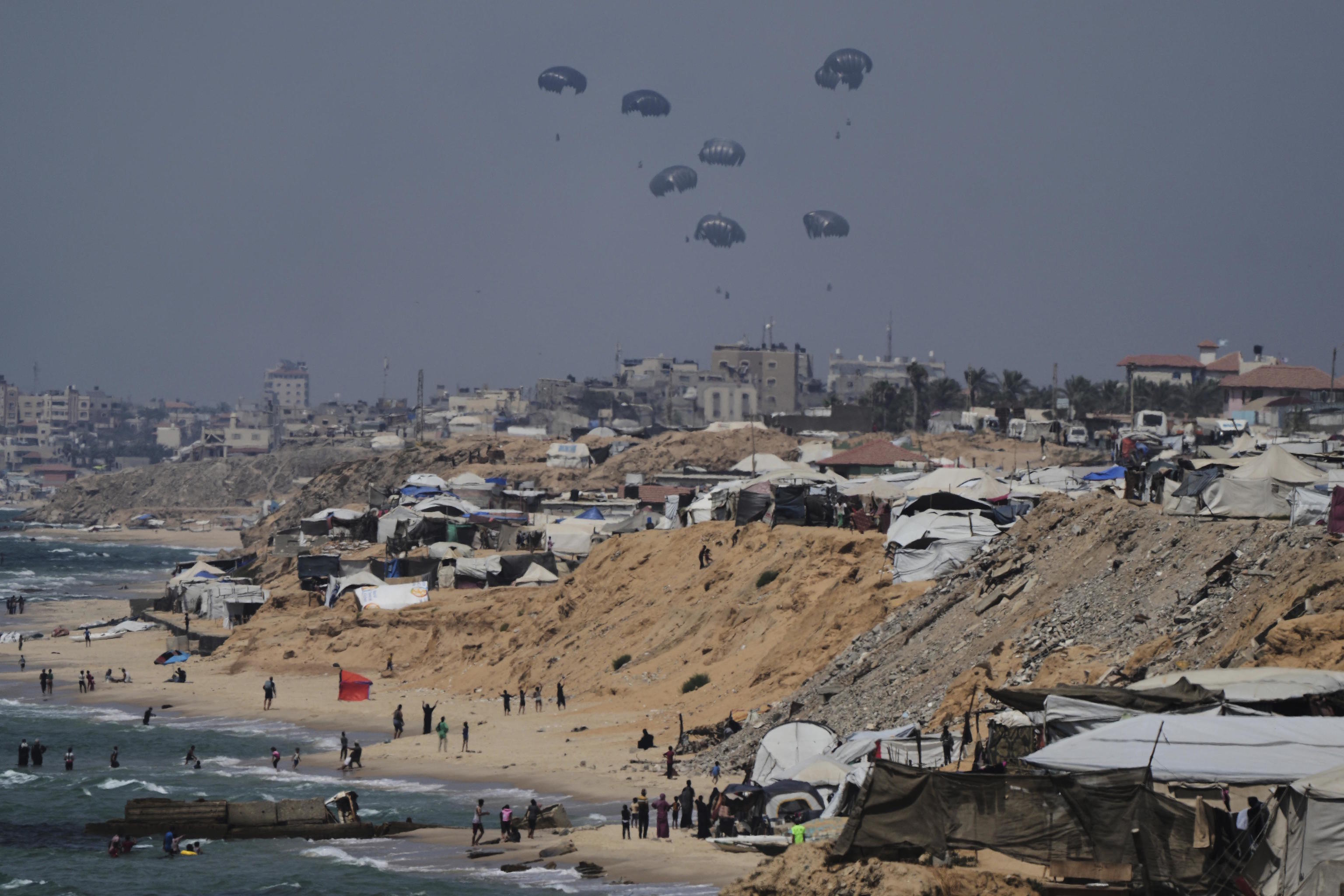 Humanitarian aid is airdropped to Palestinians over Central Gaza Strip.