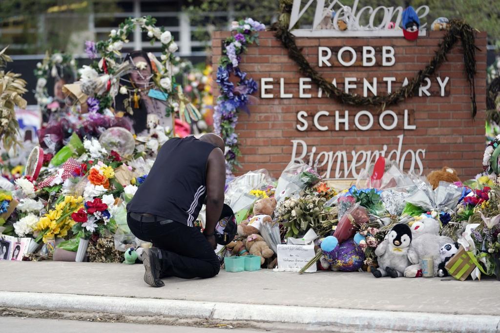 Reggie Daniels pays his respects a memorial at Robb Elementary School.