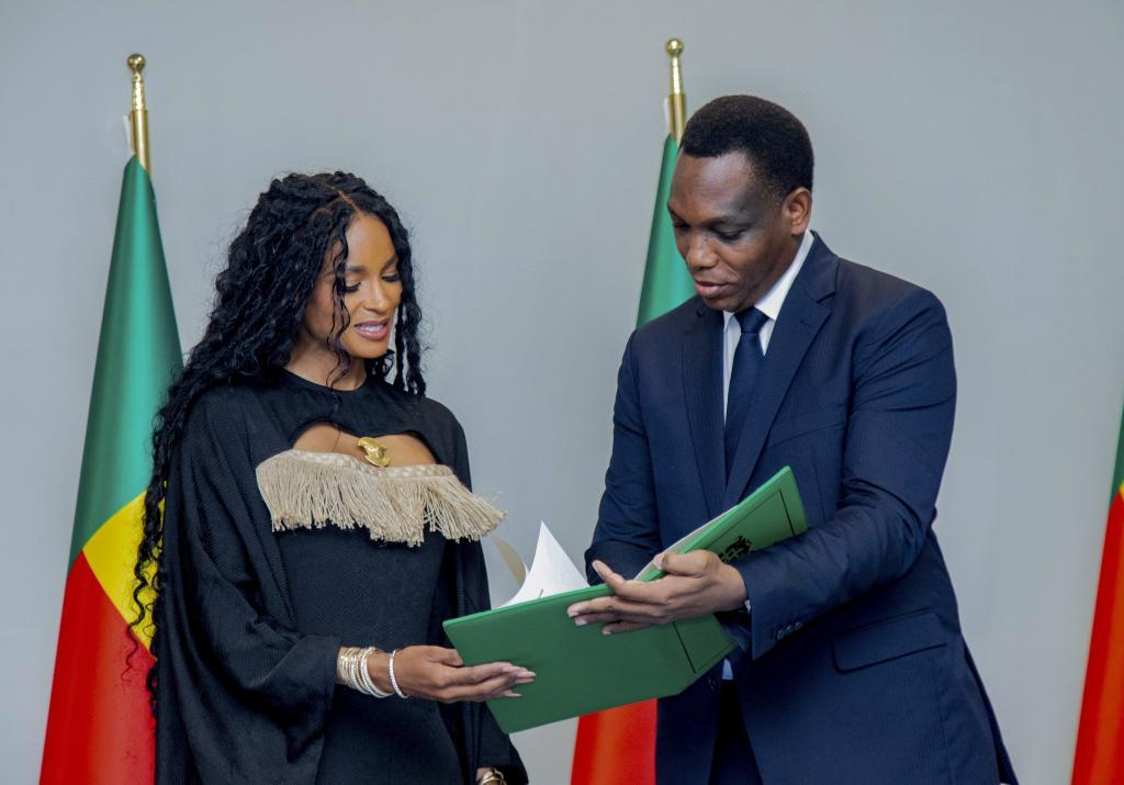 Yvon Detchenou presents citizenship documents to singer Ciara.