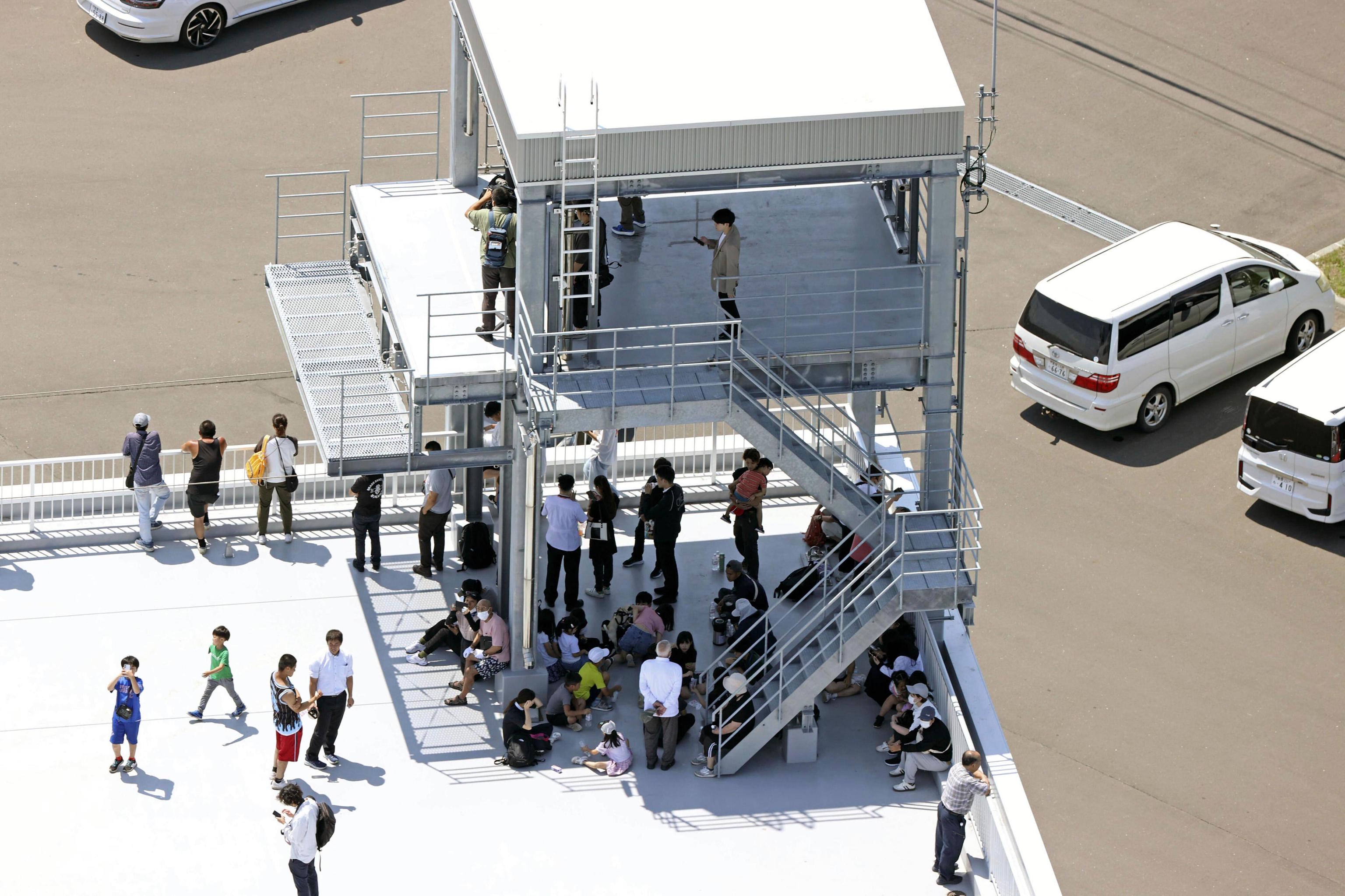 People take shelter on the roof in Japan after a powerful earthquake in Russia.