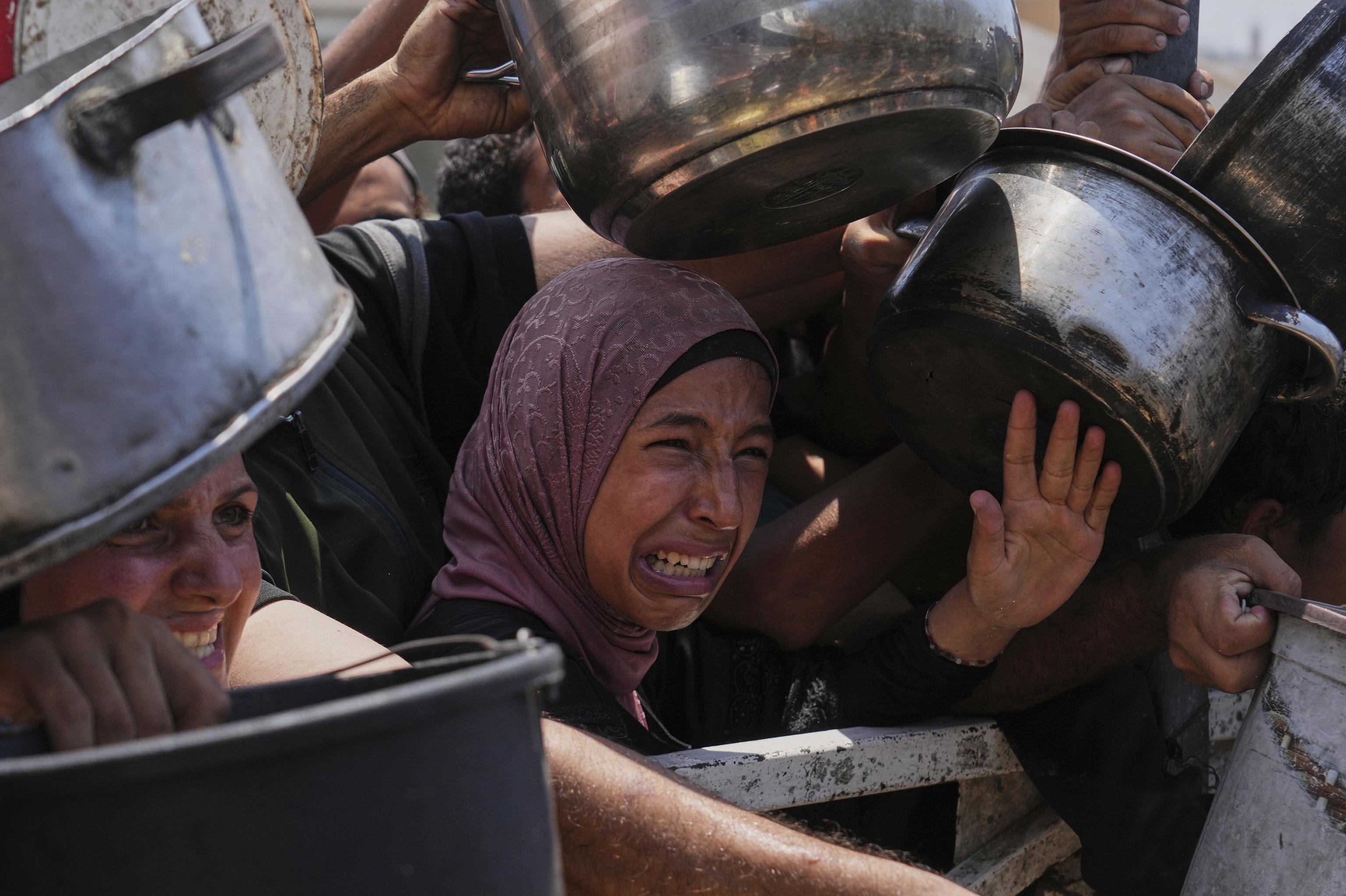 Several Palestinians struggle to obtain food in Gaza.