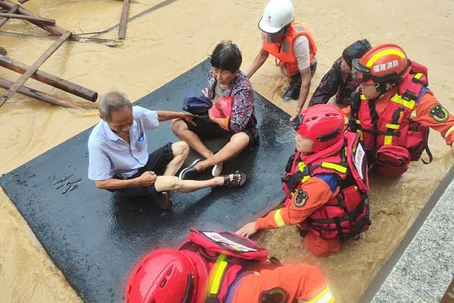 Emergency services transport two elderly people in Beijing.