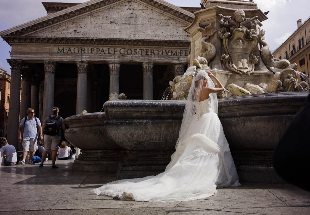 A bride poses for photos in front of Rome's Pantheon.