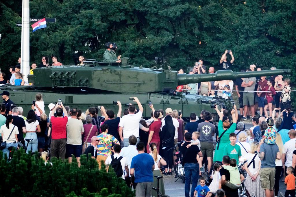 A Leopard tank takes part in a military parade marking 30 years.