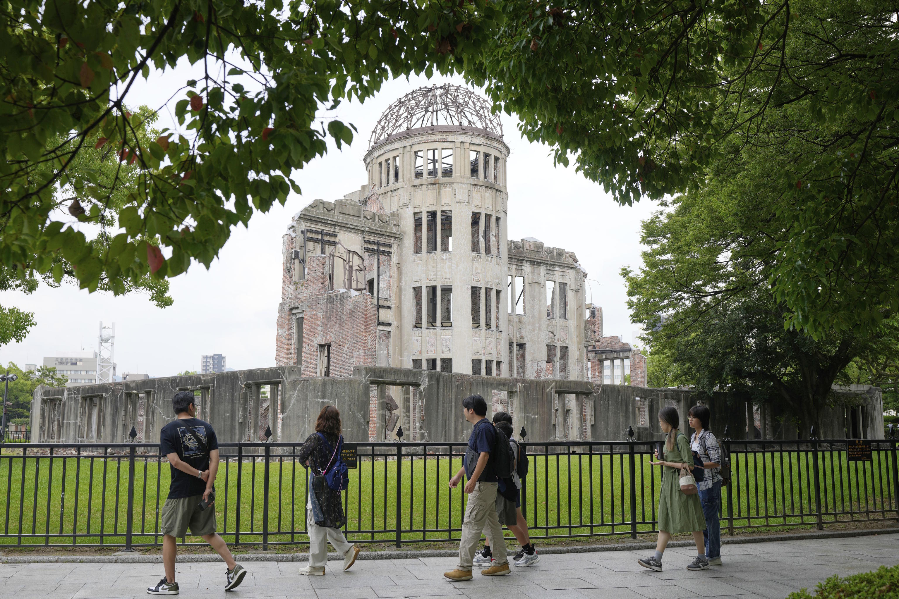 Tourists walk past the Atomic Bomb Dome in Hiroshima.