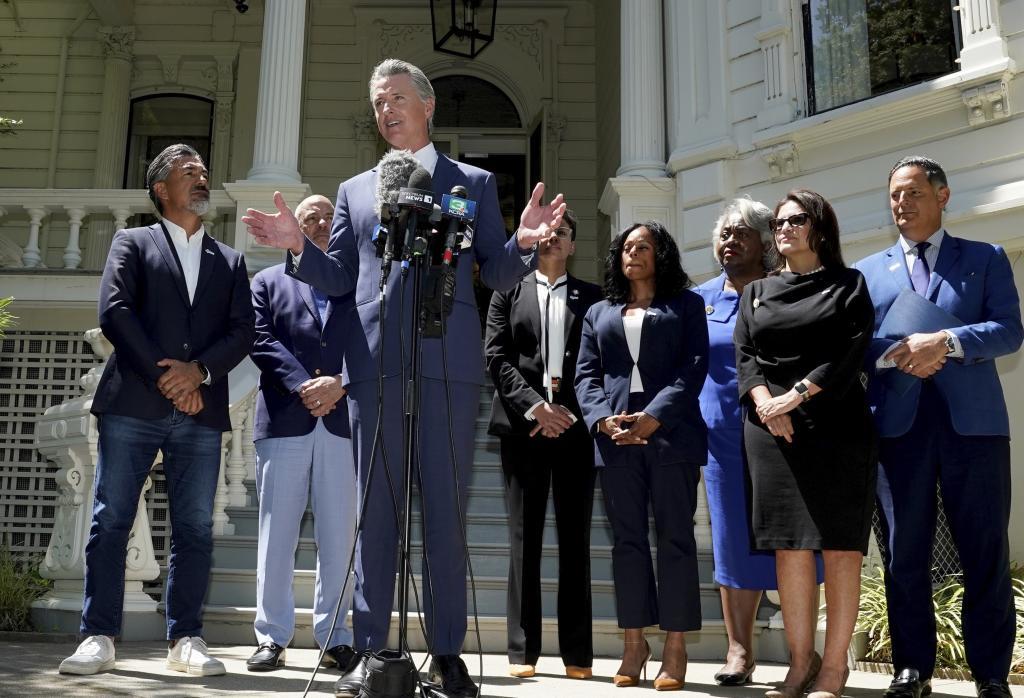 California Gov. Gavin Newsom, accompanied by several members of the Texas state Legislature