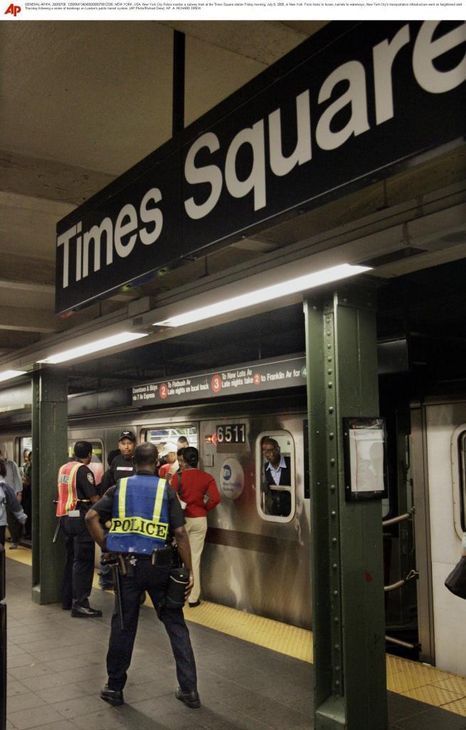 New York City Police monitor a subway train at the Times Square station