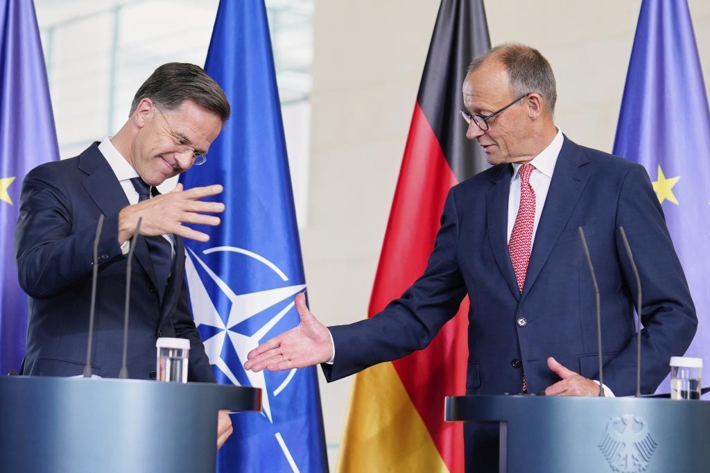 German Chancellor Friedrich Merz, right, and NATO Secretary General Mark Rutte shake hands