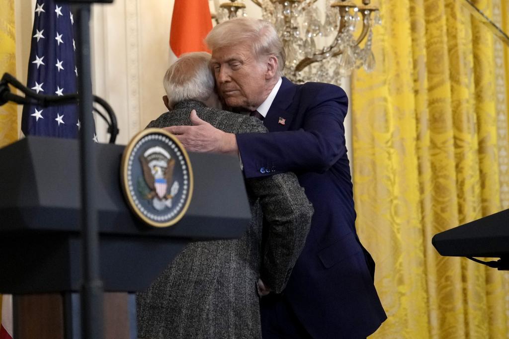 President Donald Trump, right, hugs India's Prime Minister Narendra Modi