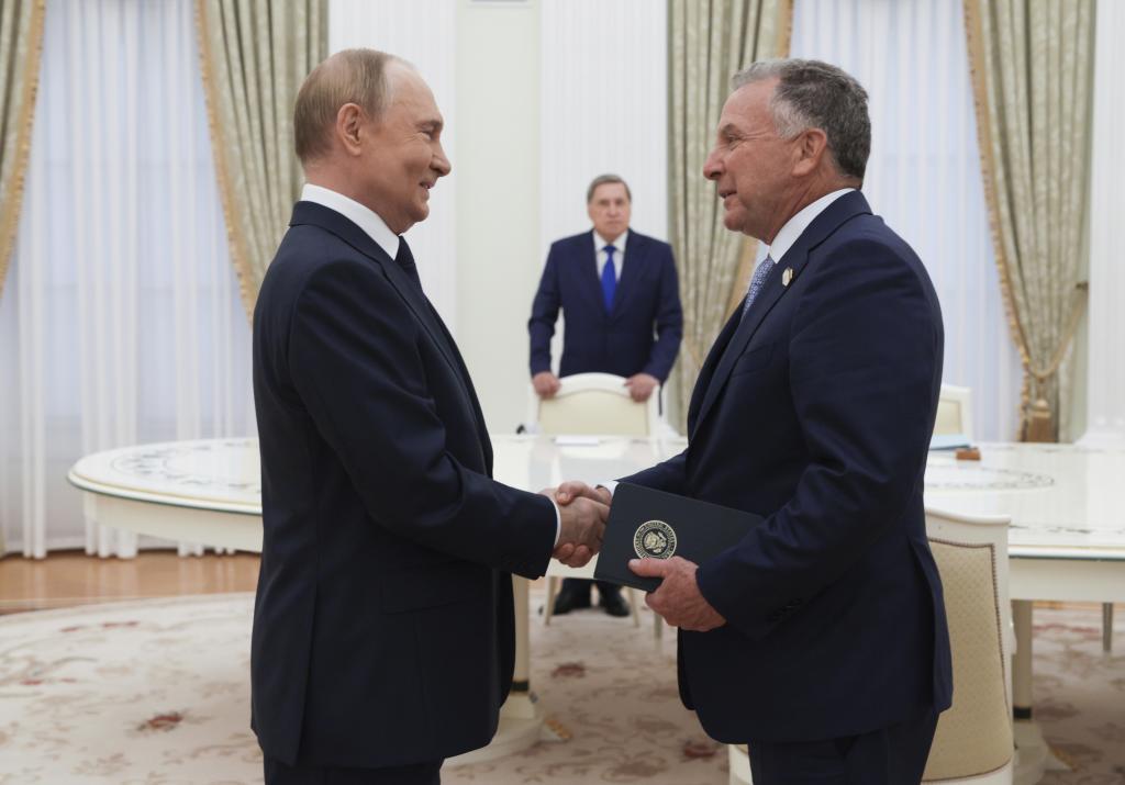 Russian President Vladimir Putin, left, and U.S. President Donald Trump's special envoy Steve Witkoff, right,