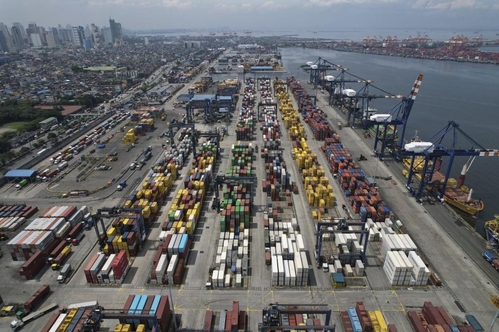A truck navigates along stacks of containers at the Manila North Harbour Port in Manila