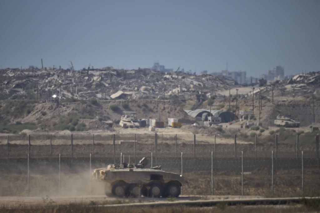 An Israeli army APC moves along the border of the Gaza Strip in southern Israel