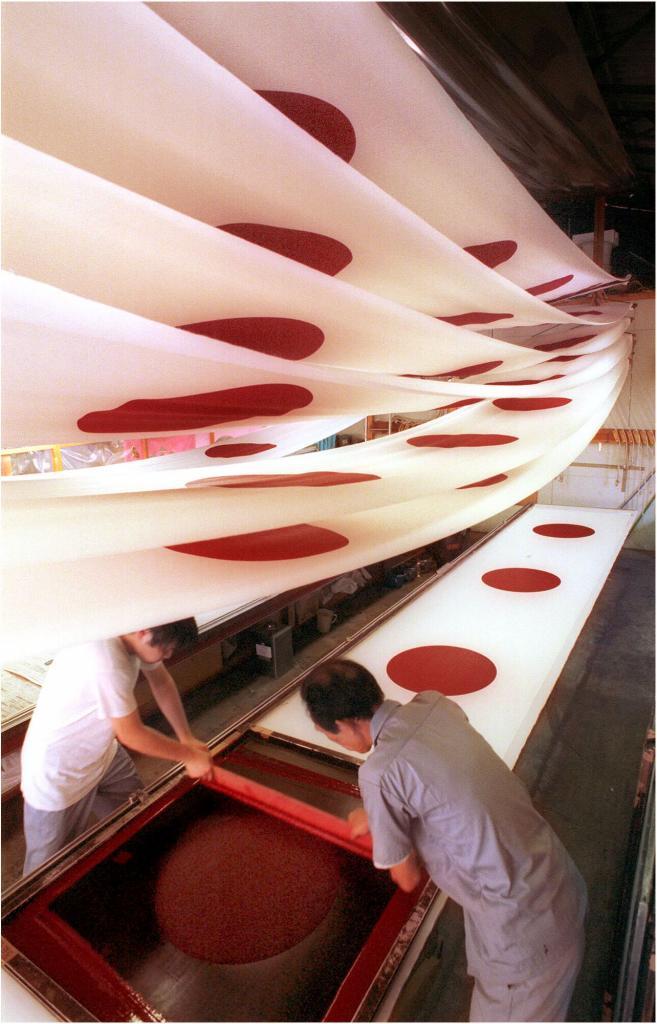 Workers at a factory in Japan make flags.