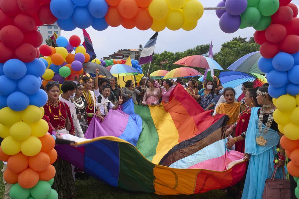 Participants hold a rainbow flag during the Pride Parade in Kathmandu