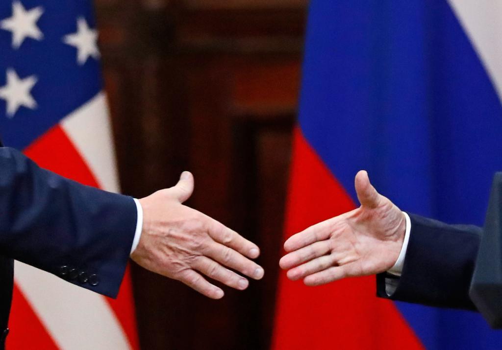 U.S. President Donald Trump shakes hand with Russian President Vladimir Putin