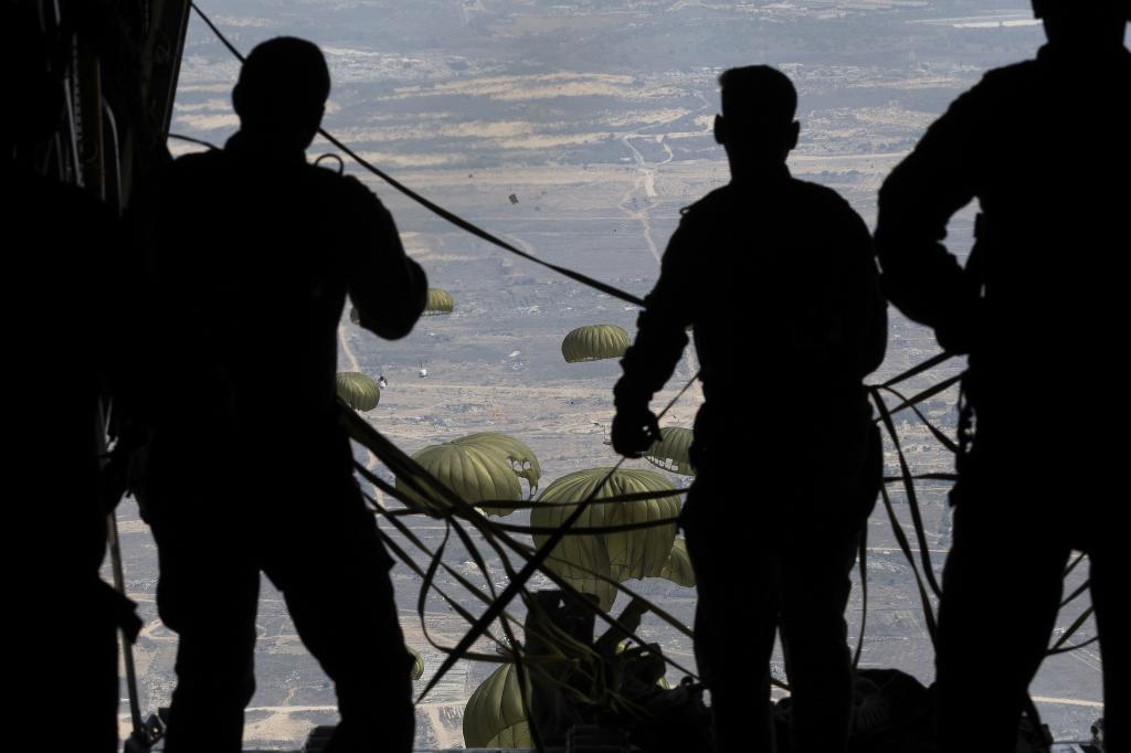Members of the Jordanian Air Force prepare a C130 Hercules carrying a shipment of humanitarian aid for airdrop over Gaza.