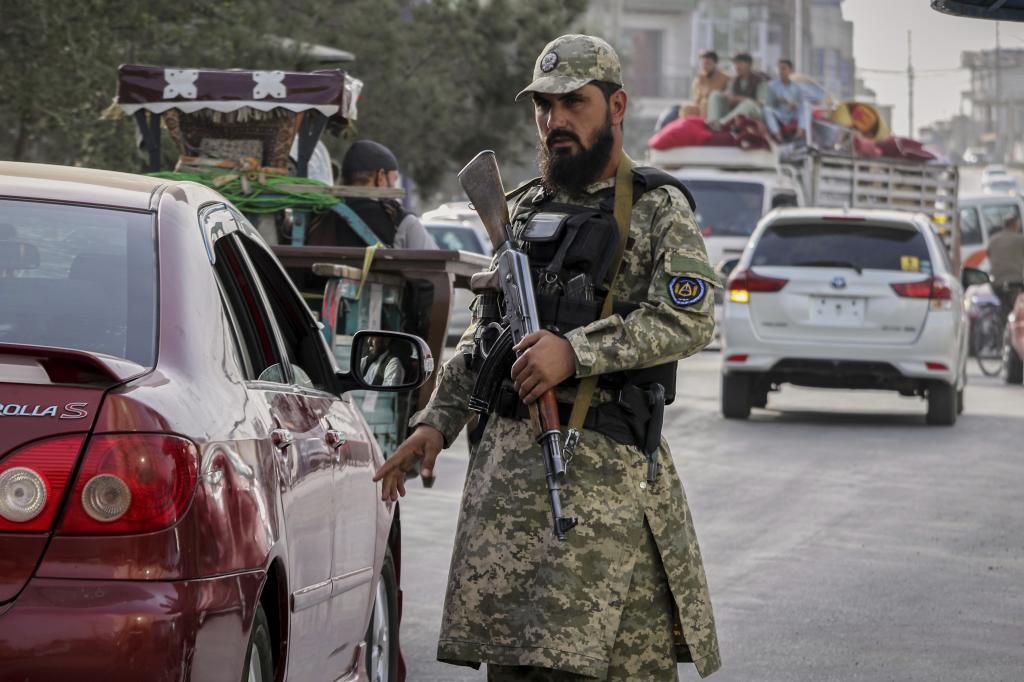 A Taliban policeman directs traffic