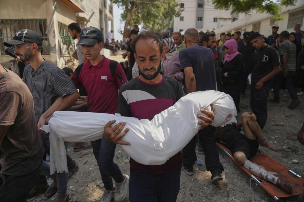 A Palestinian man carries the body of his 7-year-old nephew