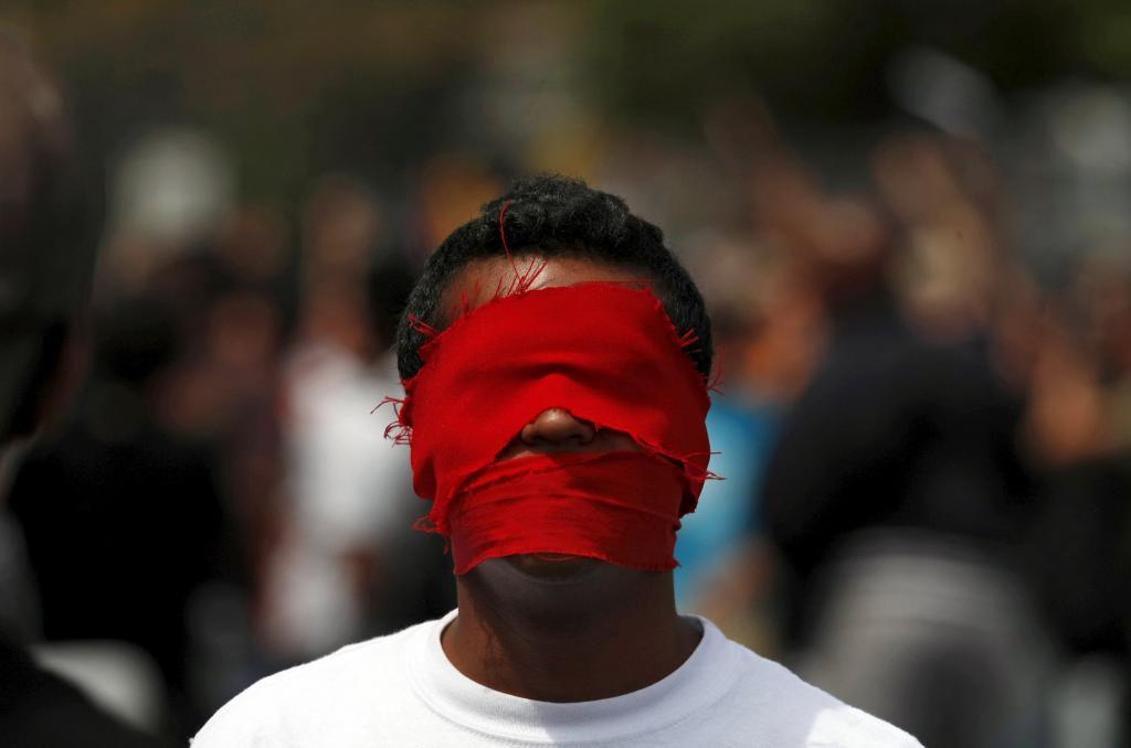 A man with his eyes and mouth covered.