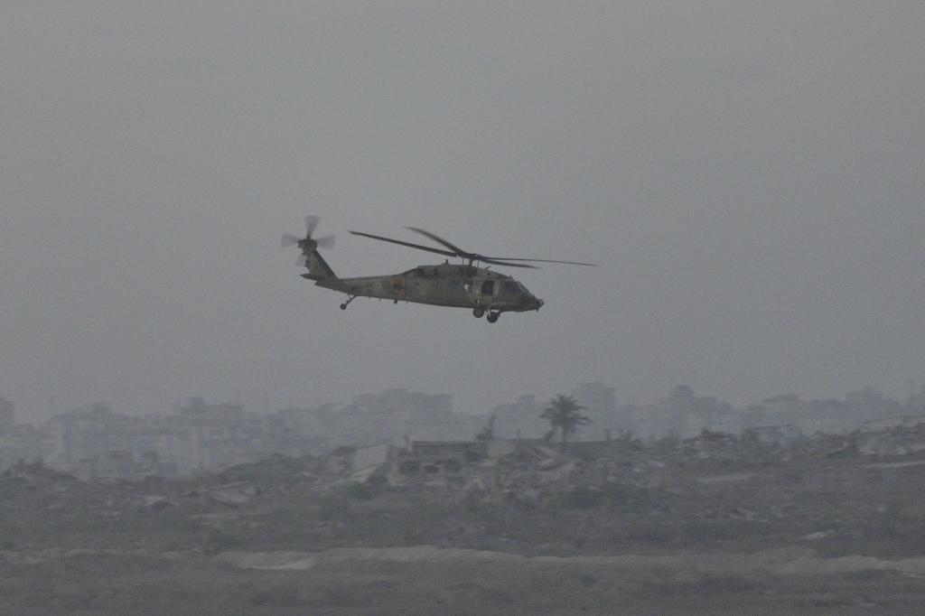 An Israeli military helicopter flies near the Israeli-Gaza border