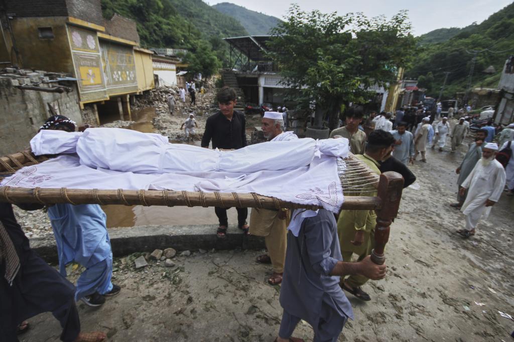 Neighbors carry a child's body for a funeral.