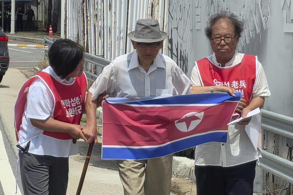 Ahn Hak-sop, center, a 95-year-old former North Korean soldier who spent decades imprisoned in the South