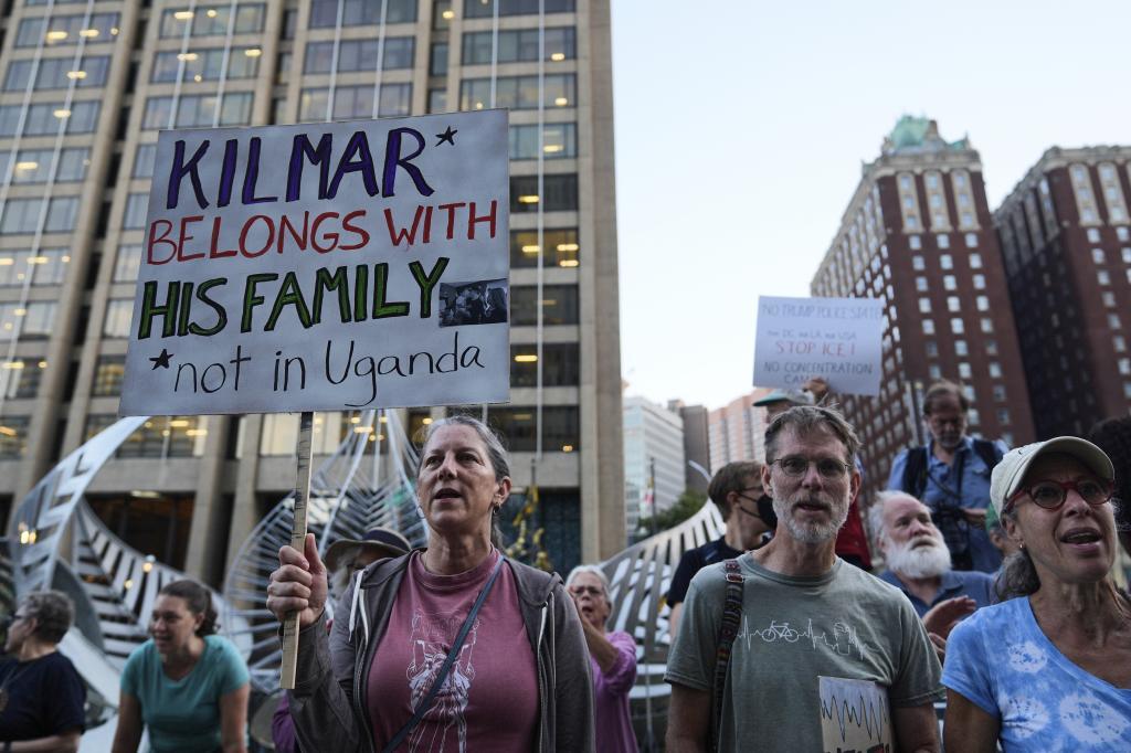 A group of people participate in a protest in front of the Immigration and Customs Enforcement field office in Baltimore.
