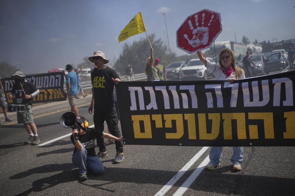 Demonstrators block a highway during a protest demanding the immediate release of all hostages held by Hamas and calling for the end of the war in the Gaza Strip