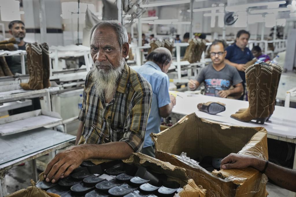 Workers assemble shoes at a leather footwear factory in Agra.