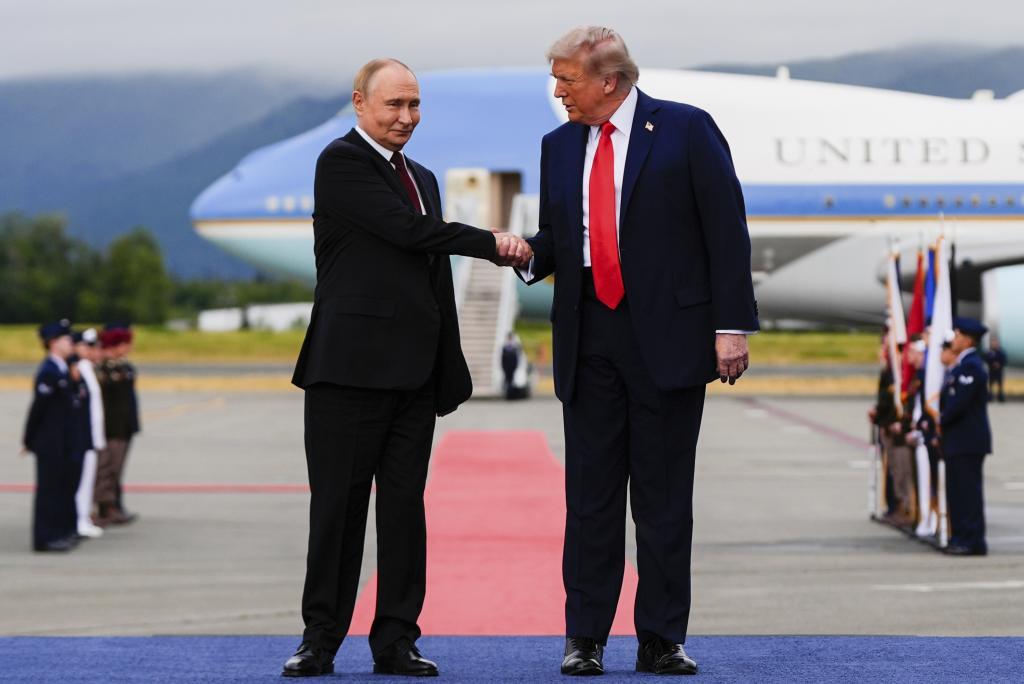President Donald Trump greets Russia's President Vladimir Putin