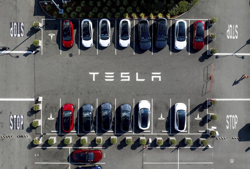 Tesla vehicles line a parking lot at the company's Fremont