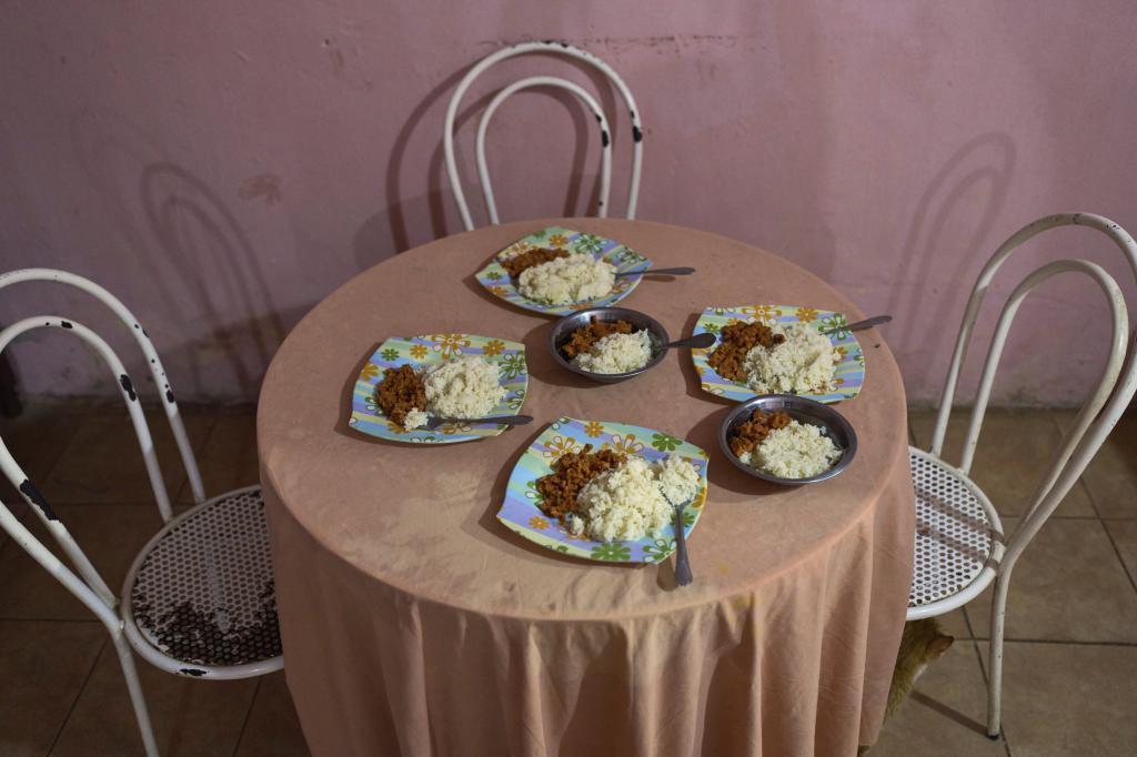Plates of food are set on the dinner table.