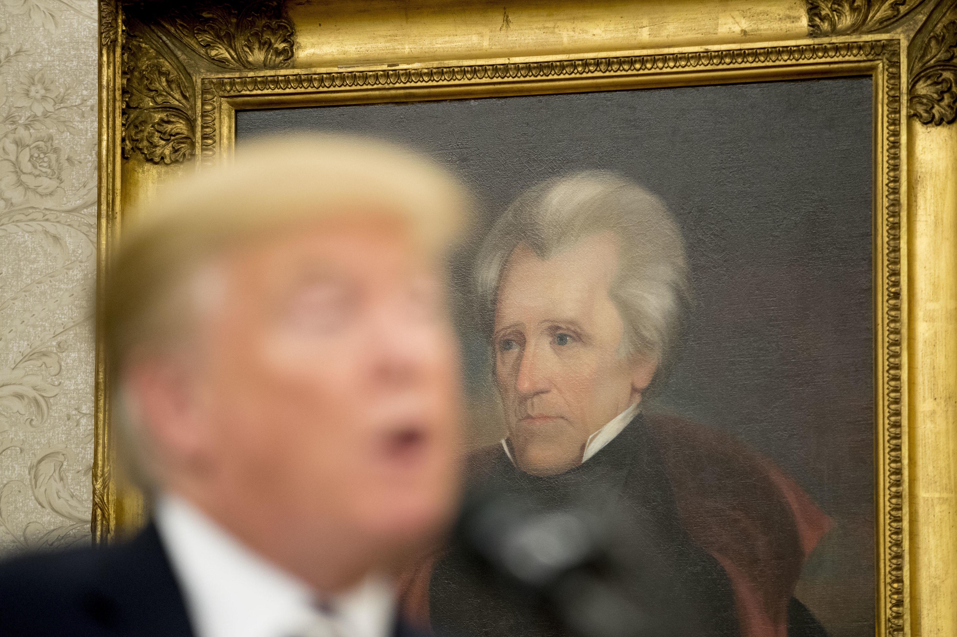 A painting of former President Andrew Jackson is visible behind Trump.