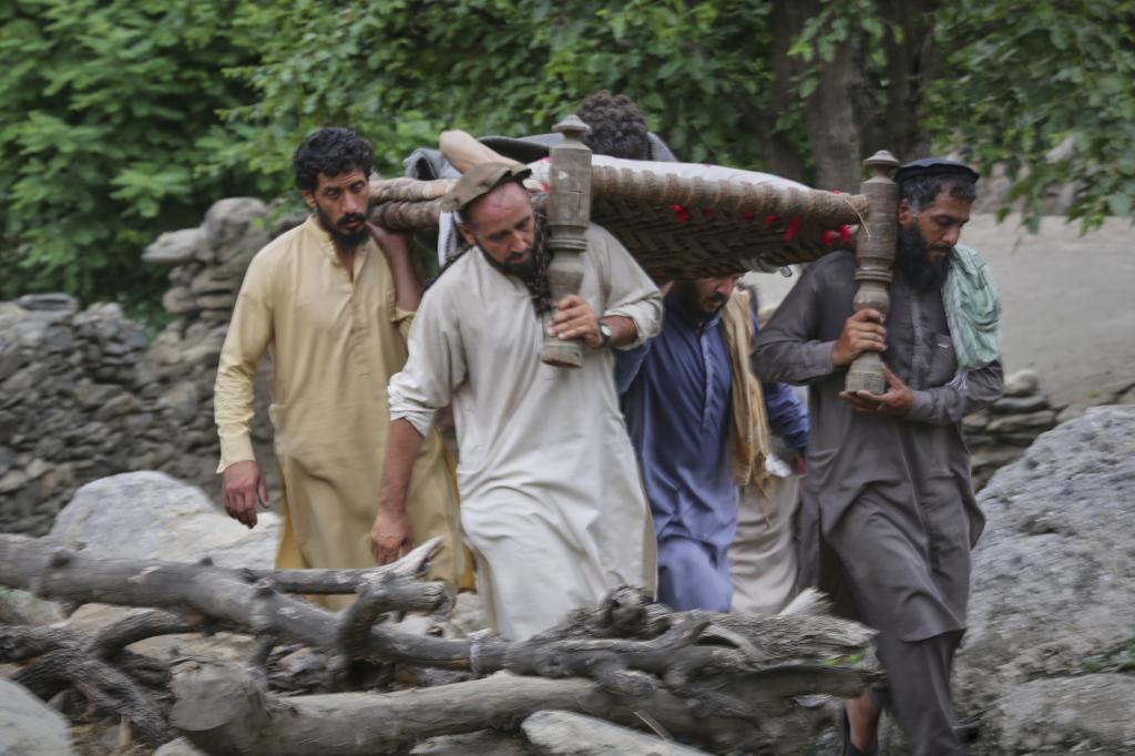 An injured person is carried to a military helicopter that landed to evacuate injured victims of an earthquake