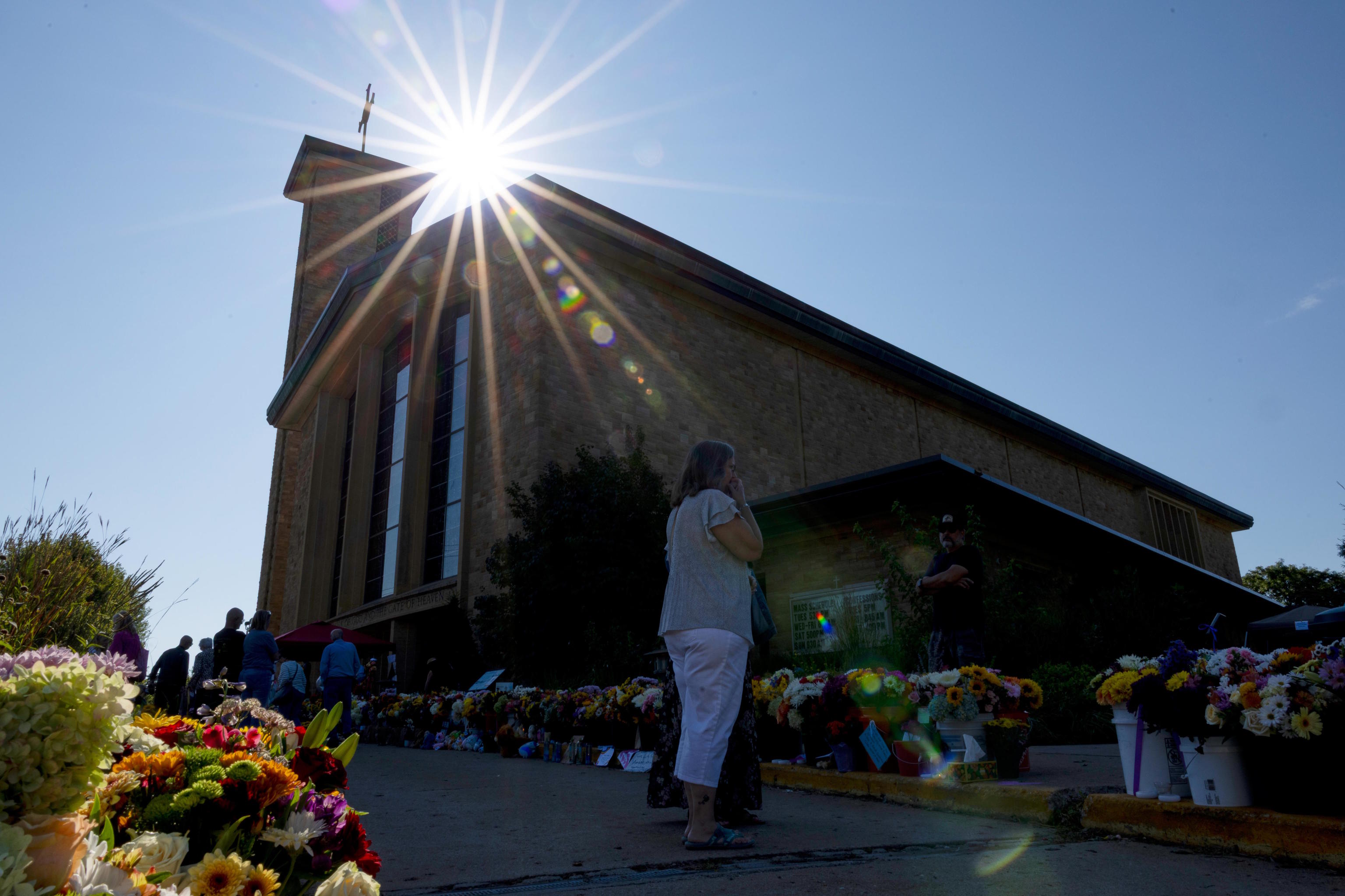 Memorial outside Annunciation Catholic Church during Mass after Wednesday's shooting.