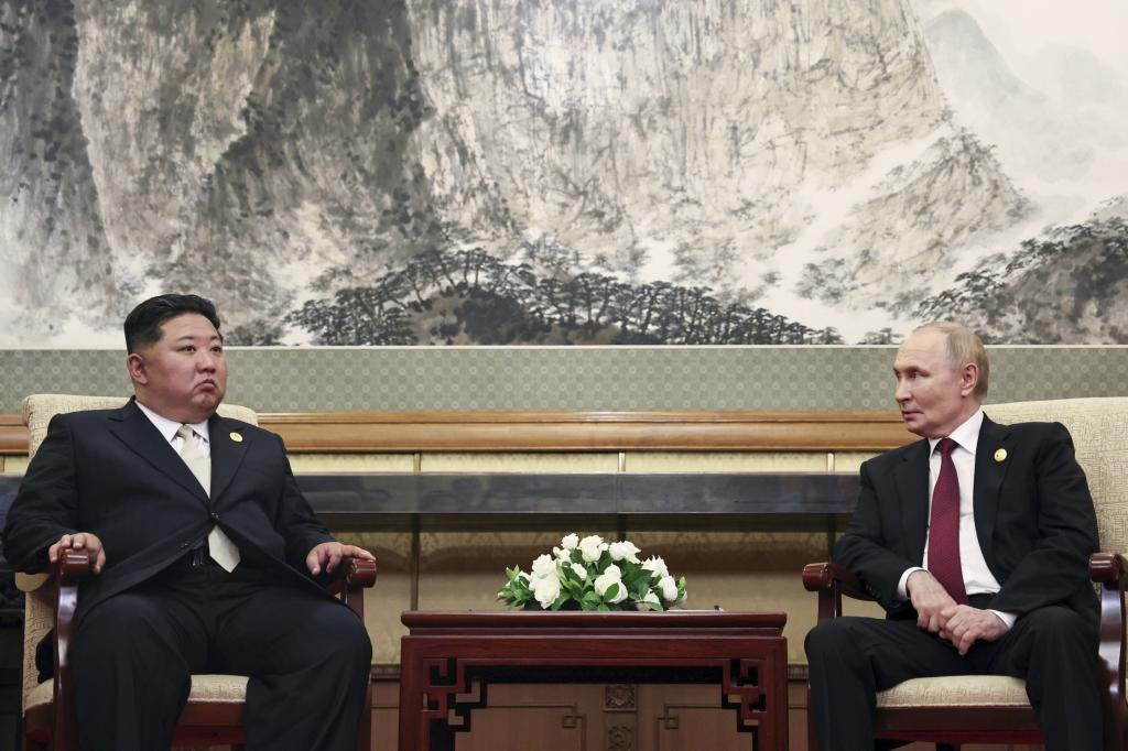 Russian President Vladimir Putin, right, speaks with North Korean leader Kim Jong Un