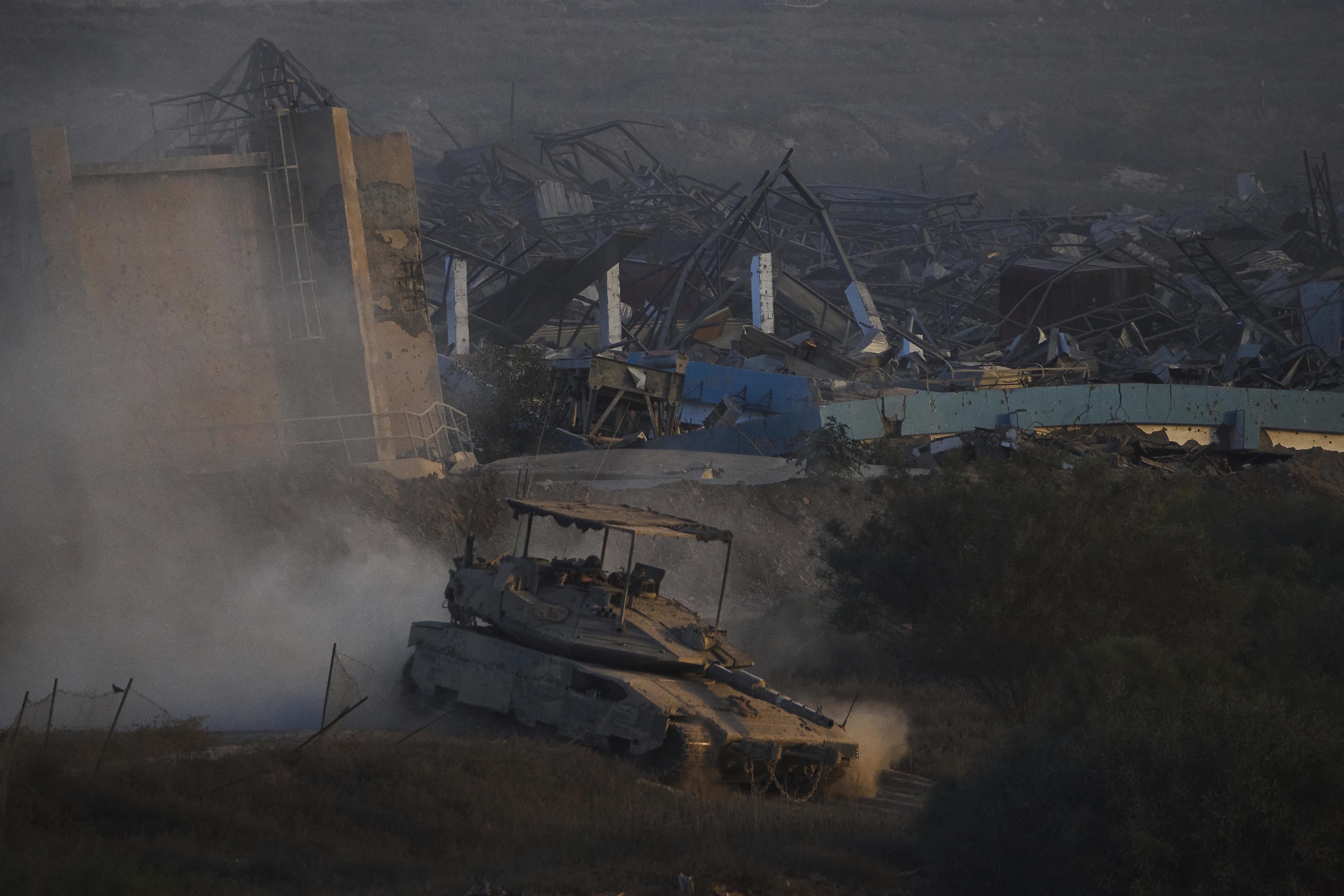 Israeli soldiers drive a tank inside the Gaza Strip.