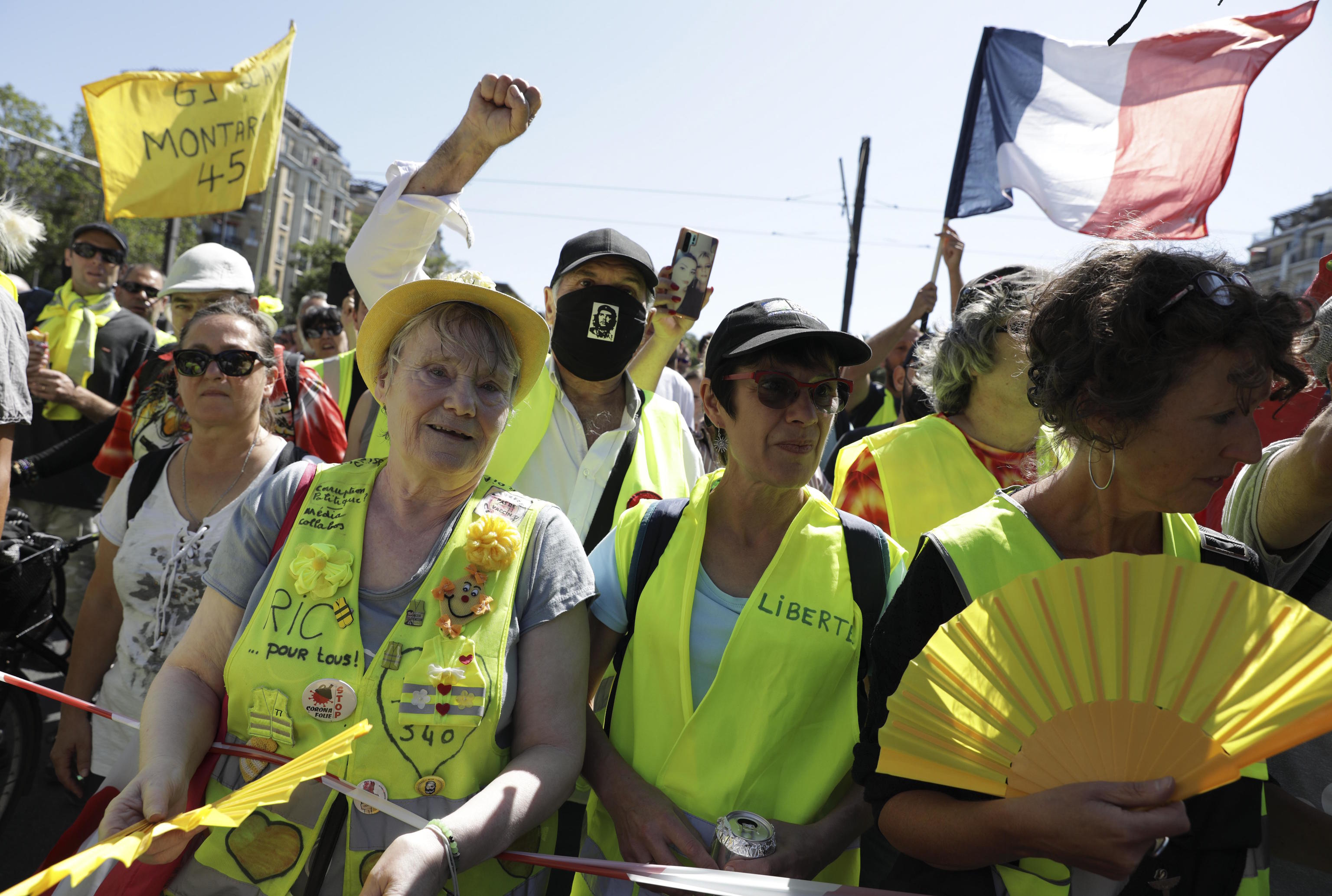 Demonstrators wearing yellow vests march in Paris in 2021.