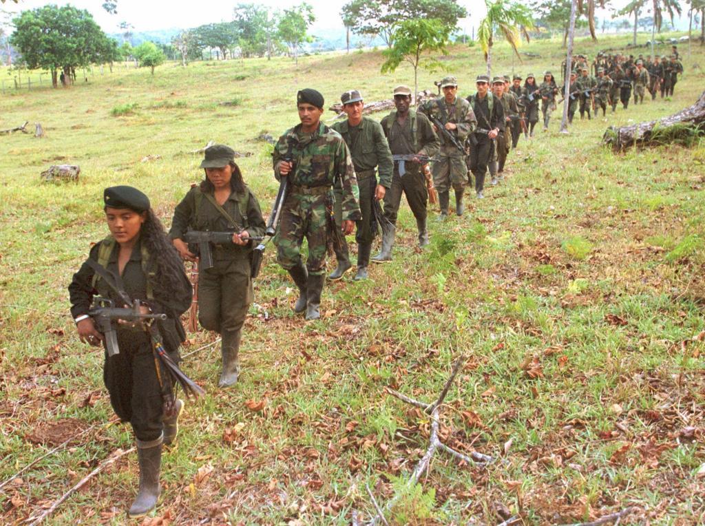 Rebel women march along with their comrades towards a camp of the Revolutionary Armed Forces of Colombia (FARC),