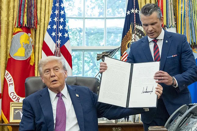 The President of the United States, Trump, with P. Hegseth in the Oval Office.