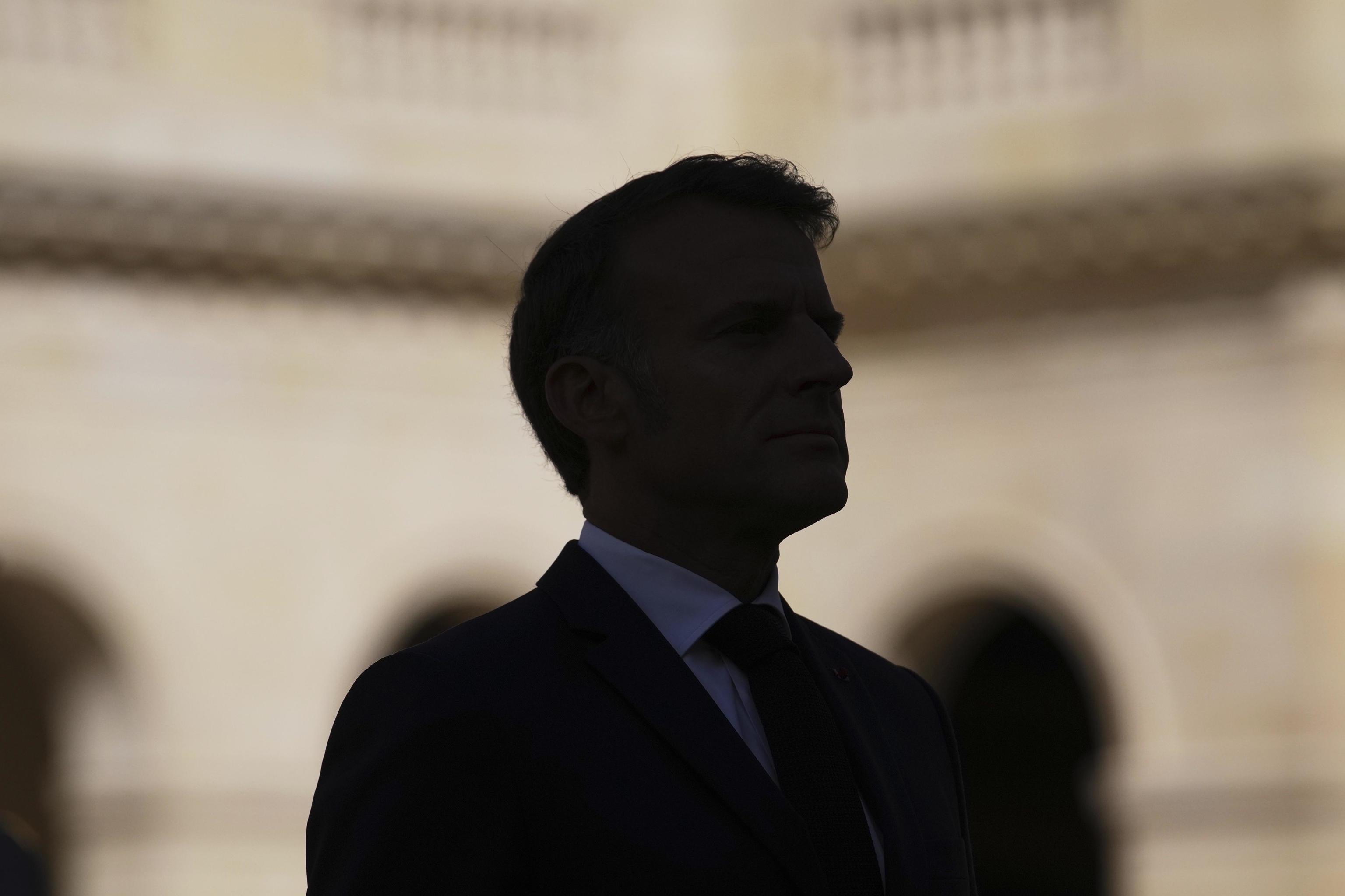 Emmanuel Macron reviews troops at Les Invalides.